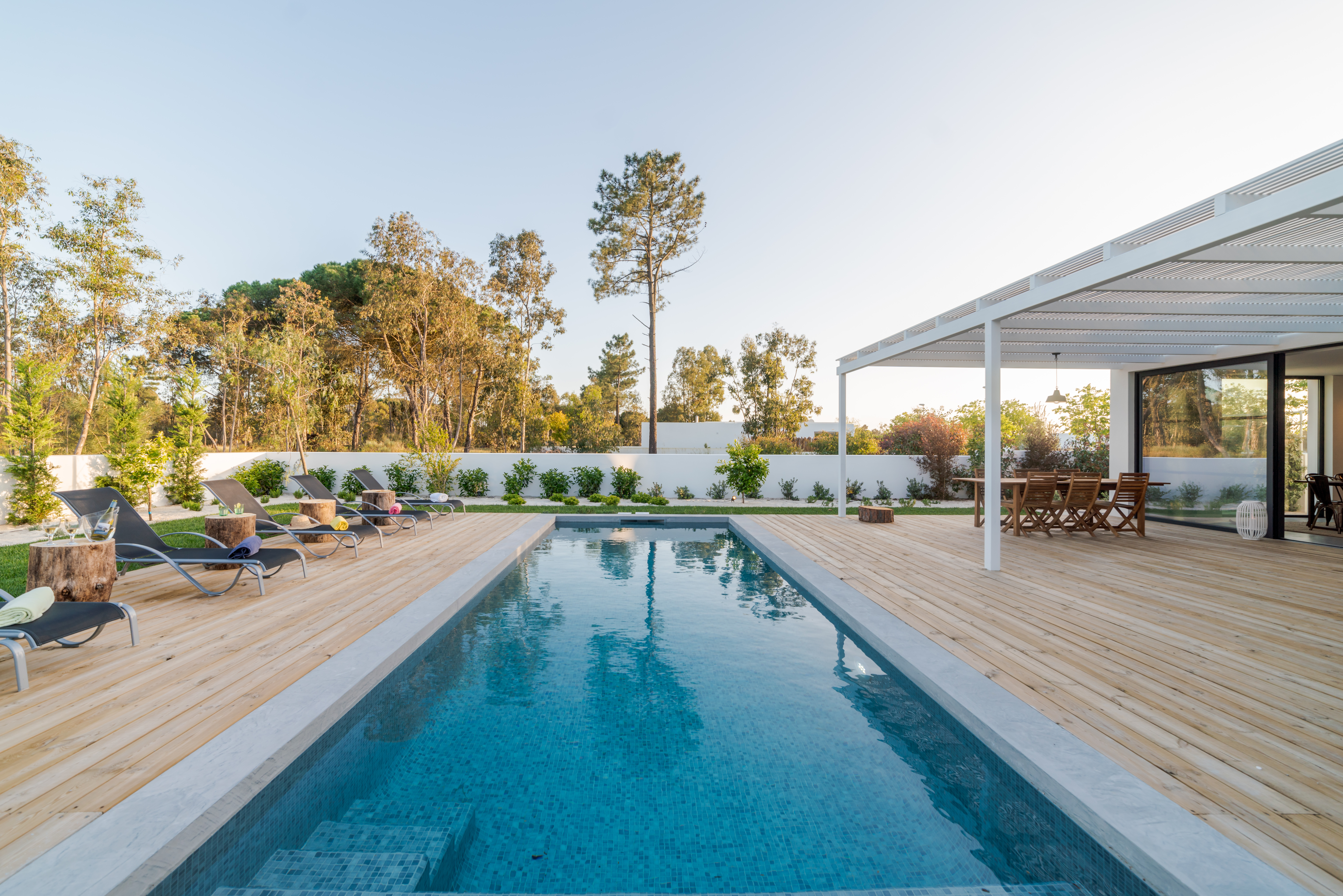 Modern house with garden swimming pool and wooden deck