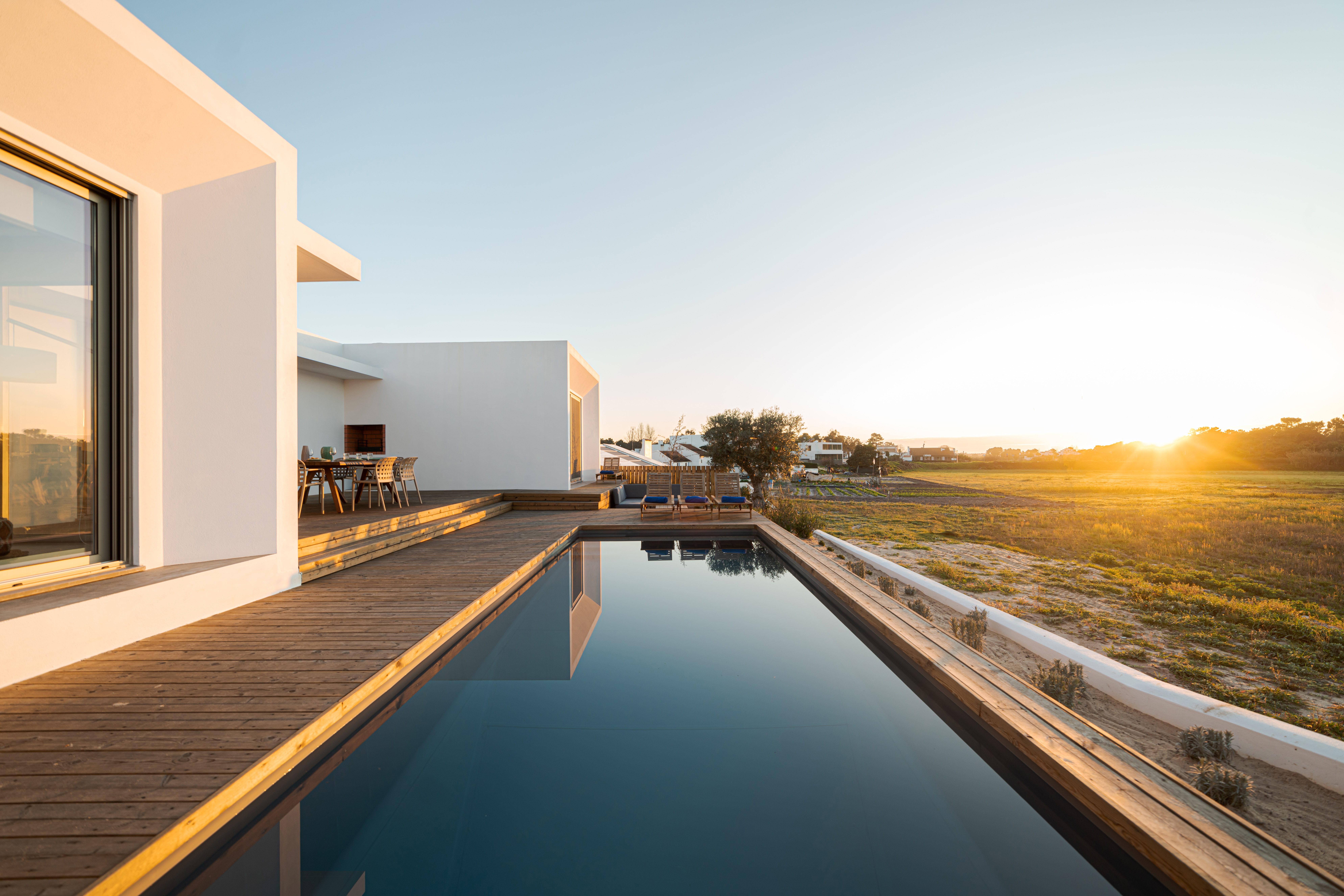 Swimming pool with wooden deck view on Modern villa