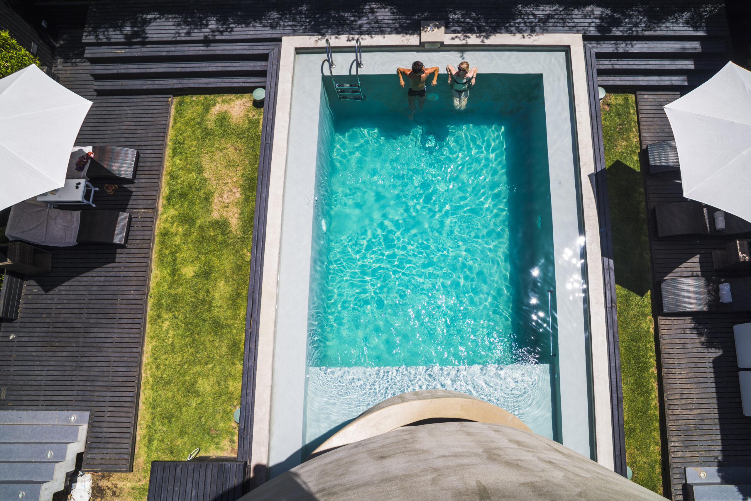 Couple at a swimming pool on vacation at luxury hotel accommodation, Santiago, Chile, South America Couple at a swimming pool on vacation at luxury hotel accommodation, Santiago, Chile, South America