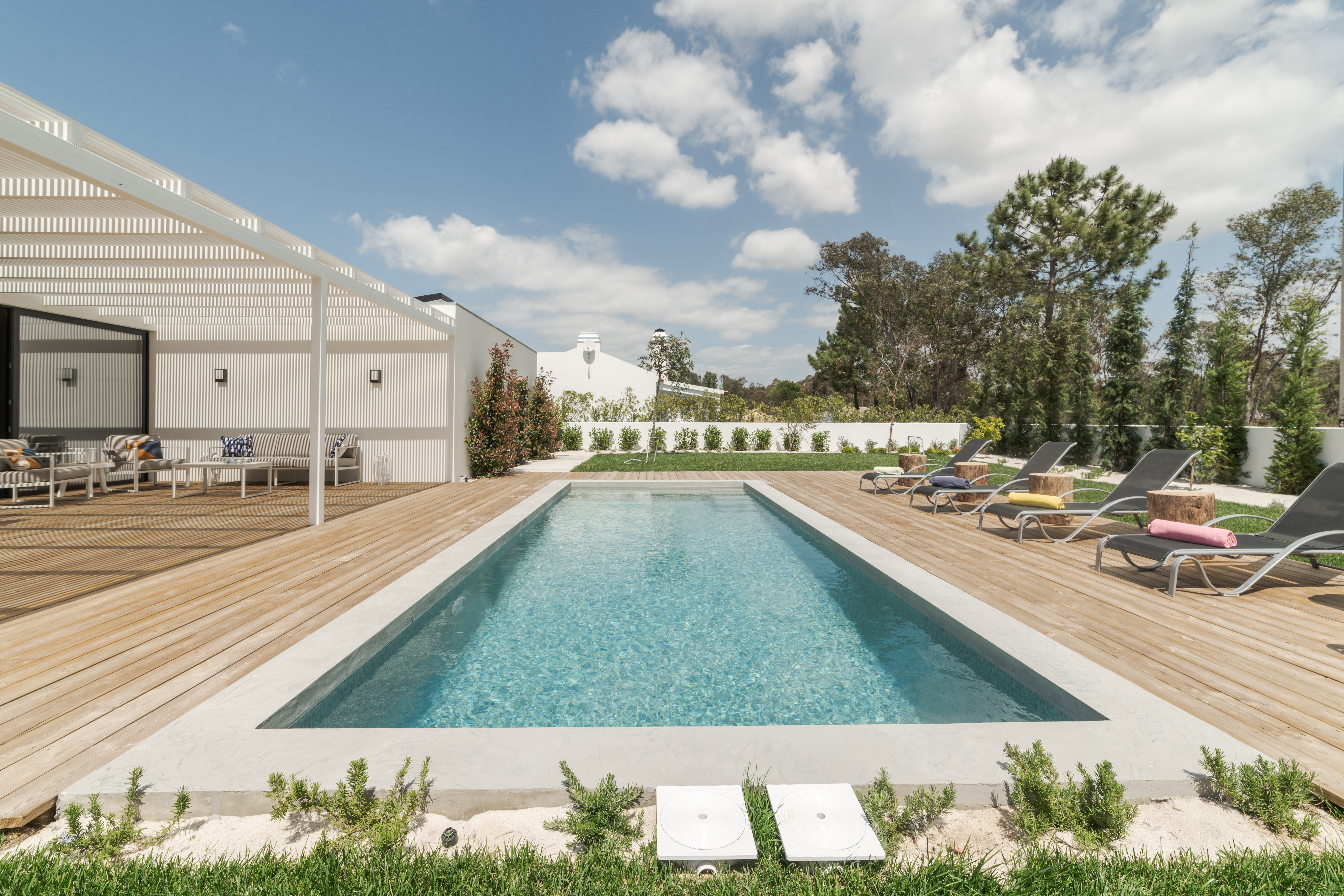 Modern house with garden swimming pool and wooden deck