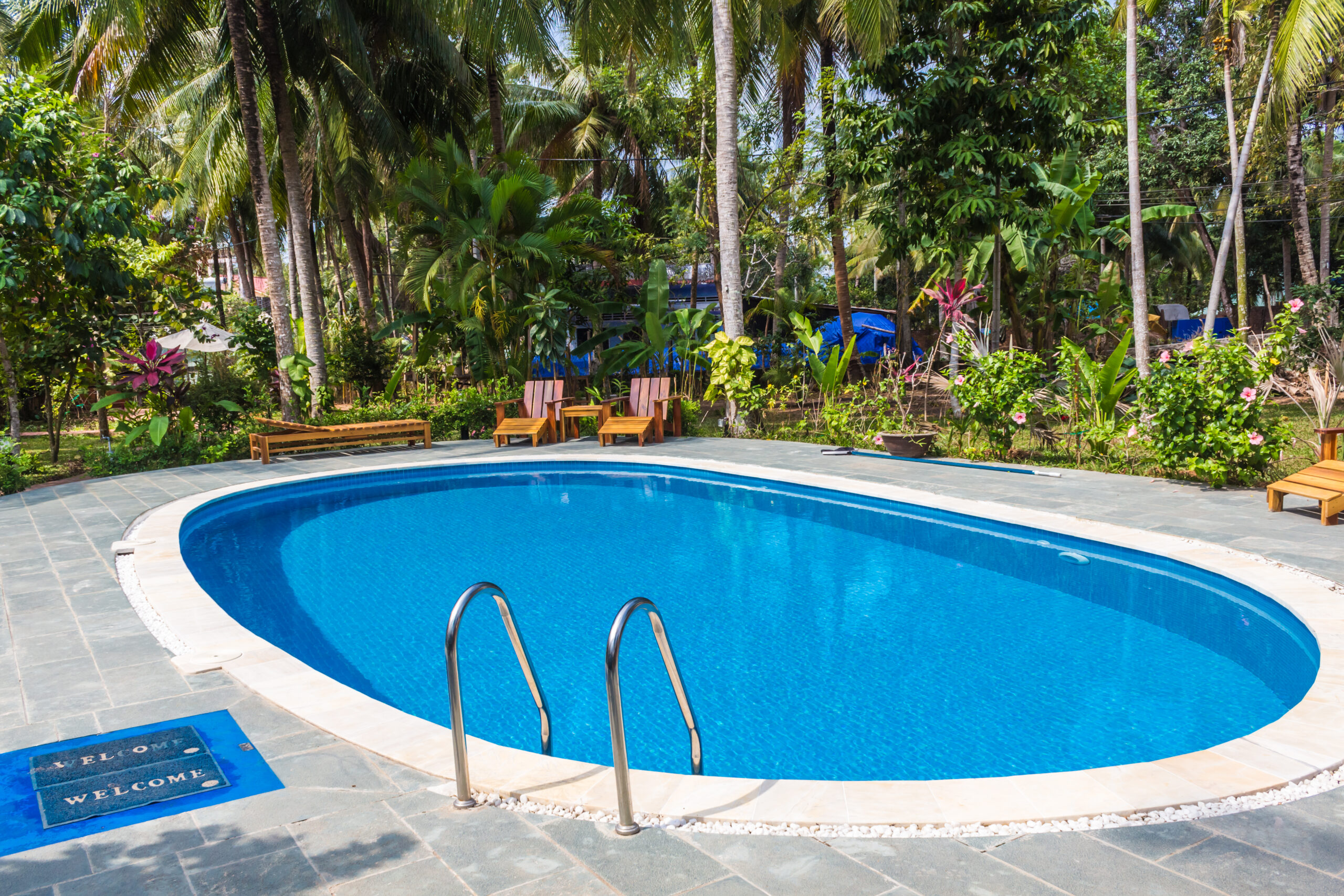 swimming pool in tropical resort with small garden