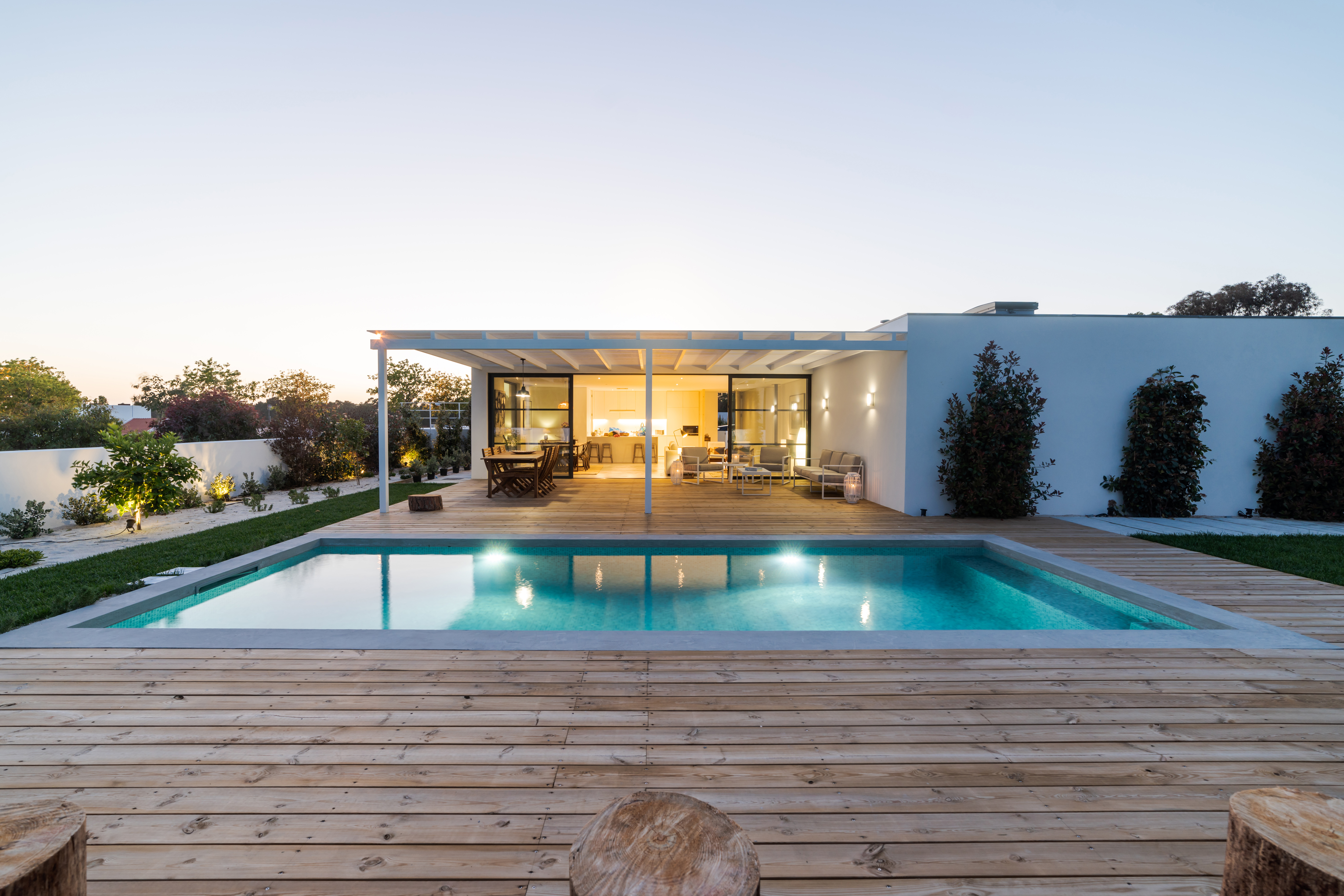Modern house with garden swimming pool and wooden deck