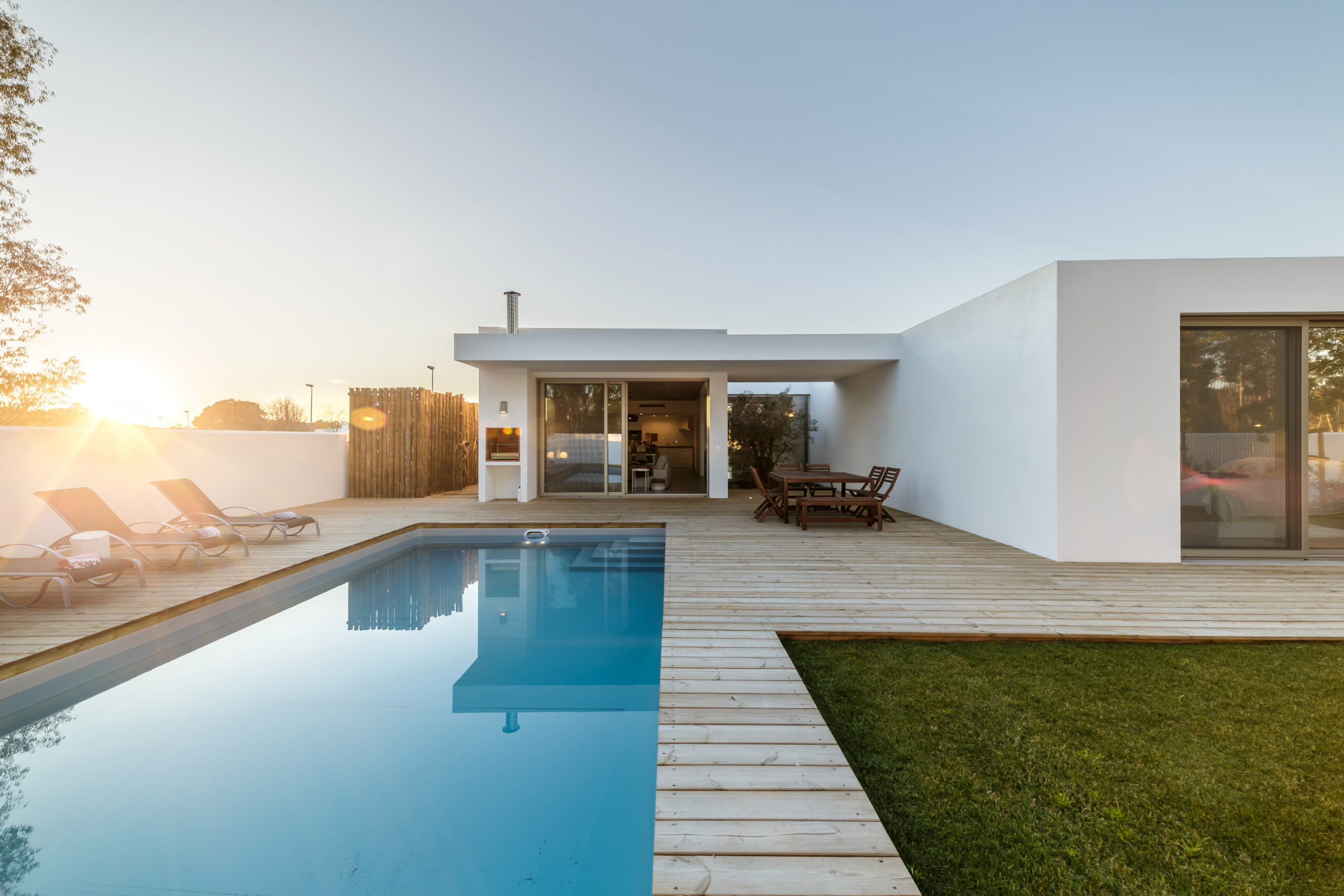 Modern house with garden swimming pool and wooden deck