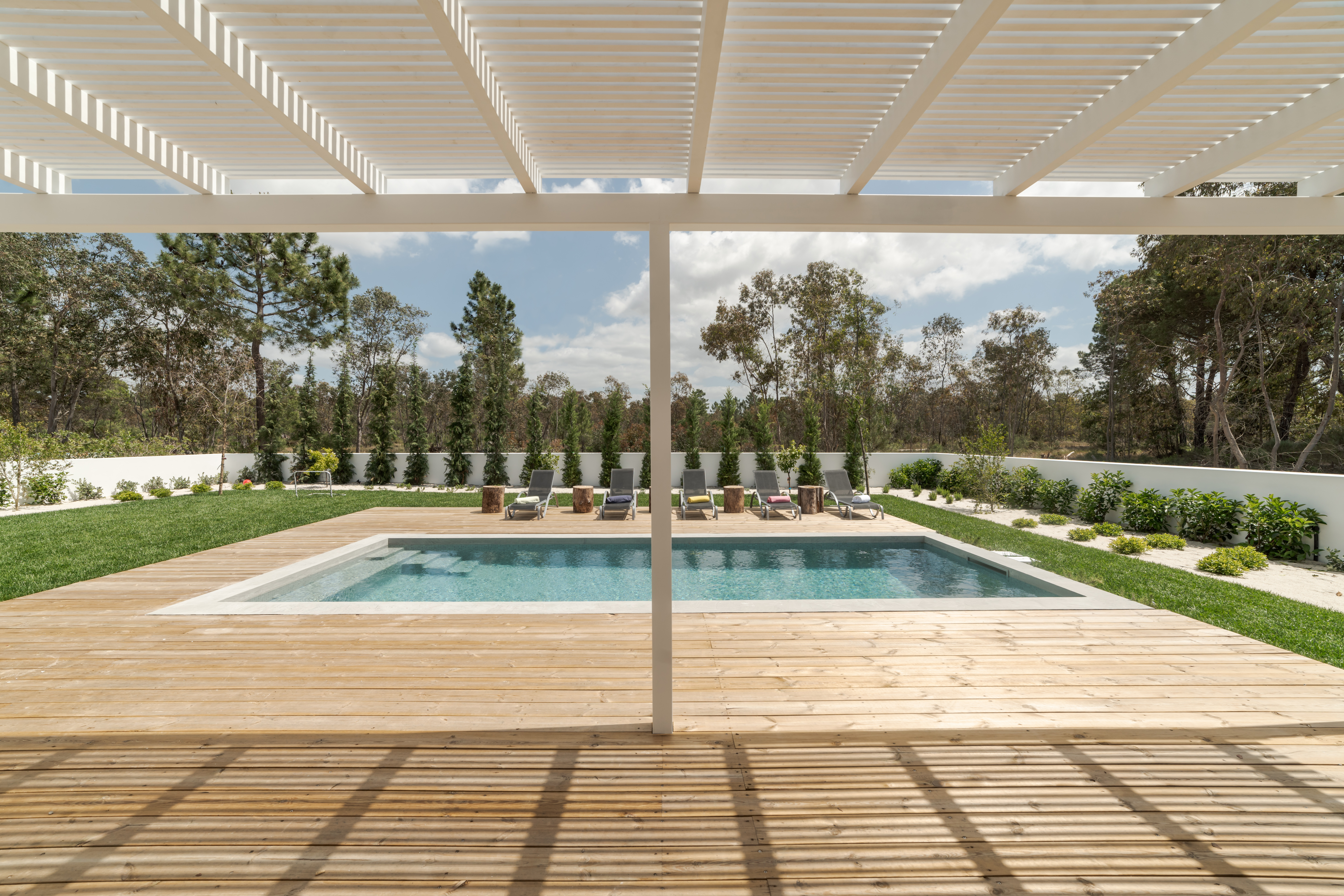 Modern house with garden swimming pool and wooden deck