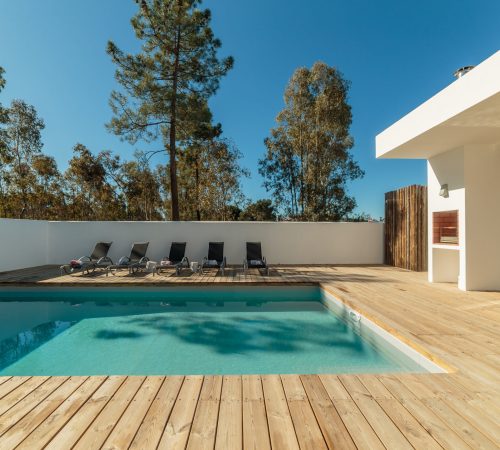 Modern house with garden swimming pool and wooden deck