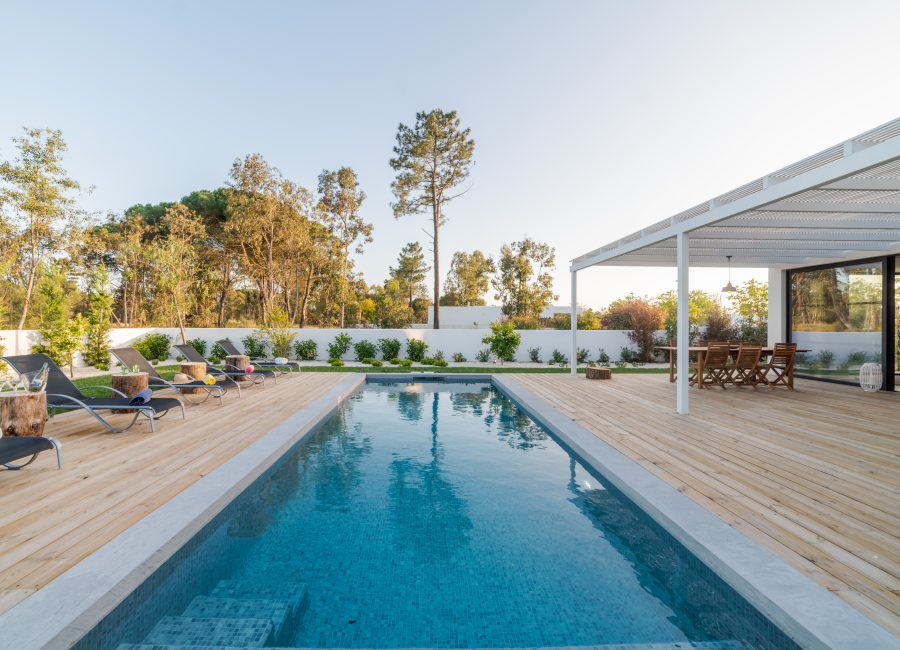 Modern house with garden swimming pool and wooden deck