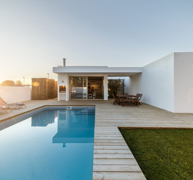 Modern house with garden swimming pool and wooden deck