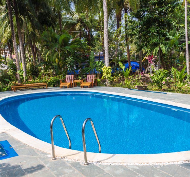 swimming pool in tropical resort with small garden